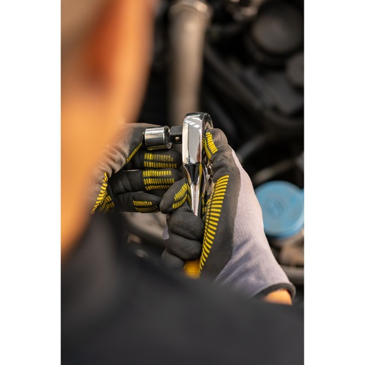 STANLEY STMT86524-0 ratchet wrench held by gloved hands during mechanical work, close-up photography.
