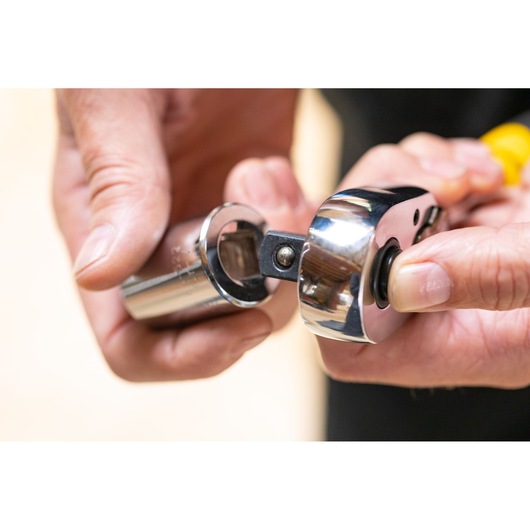 STANLEY STMT86527-0 ratchet wrench connecting to socket, close-up photo in hand, tool category