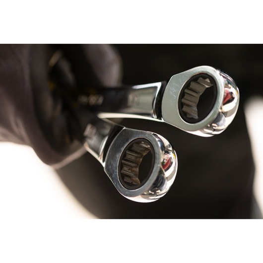STANLEY STMT89910-0 photography of two chrome ratcheting wrenches held in a gloved hand, close-up view.