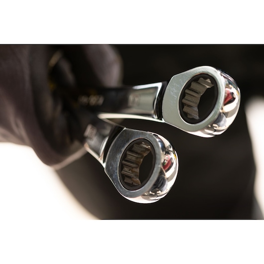 STANLEY STMT89916-0 ratcheting wrenches close-up, photography, chrome finish, held in a gloved hand.