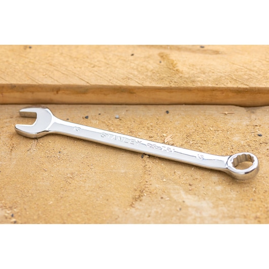 STANLEY STMT95790-0 combination wrench, silver finish, angled view, placed on wood surface.