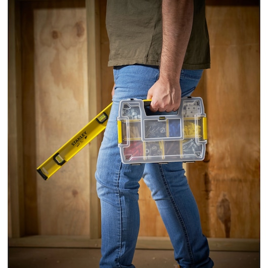 STANLEY STST1-70720 organizer box with yellow accents held by person, next to STANLEY spirit level.
