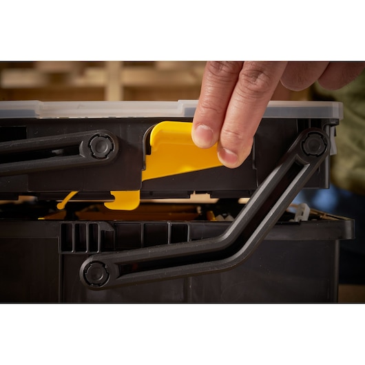 STANLEY STST1-75540 toolbox close-up showing yellow latch being operated.
