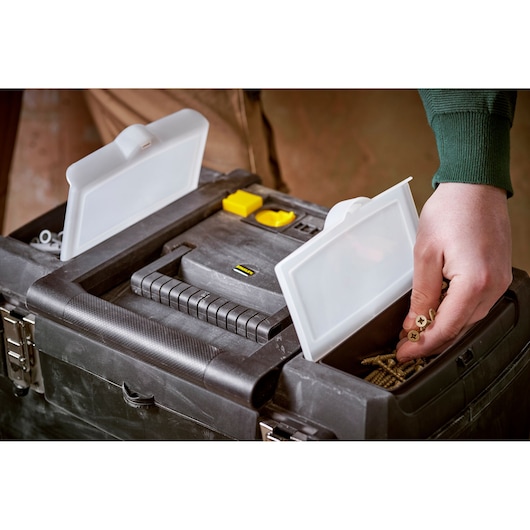 STANLEY STST1-75758 toolbox with dual compartment lids open, showing screws held in hand.
