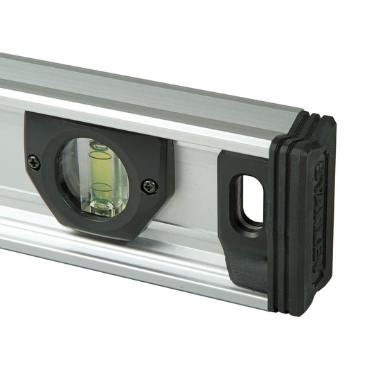 Close-up of a Stanley spirit level with a bubble vial in a silver and black frame.